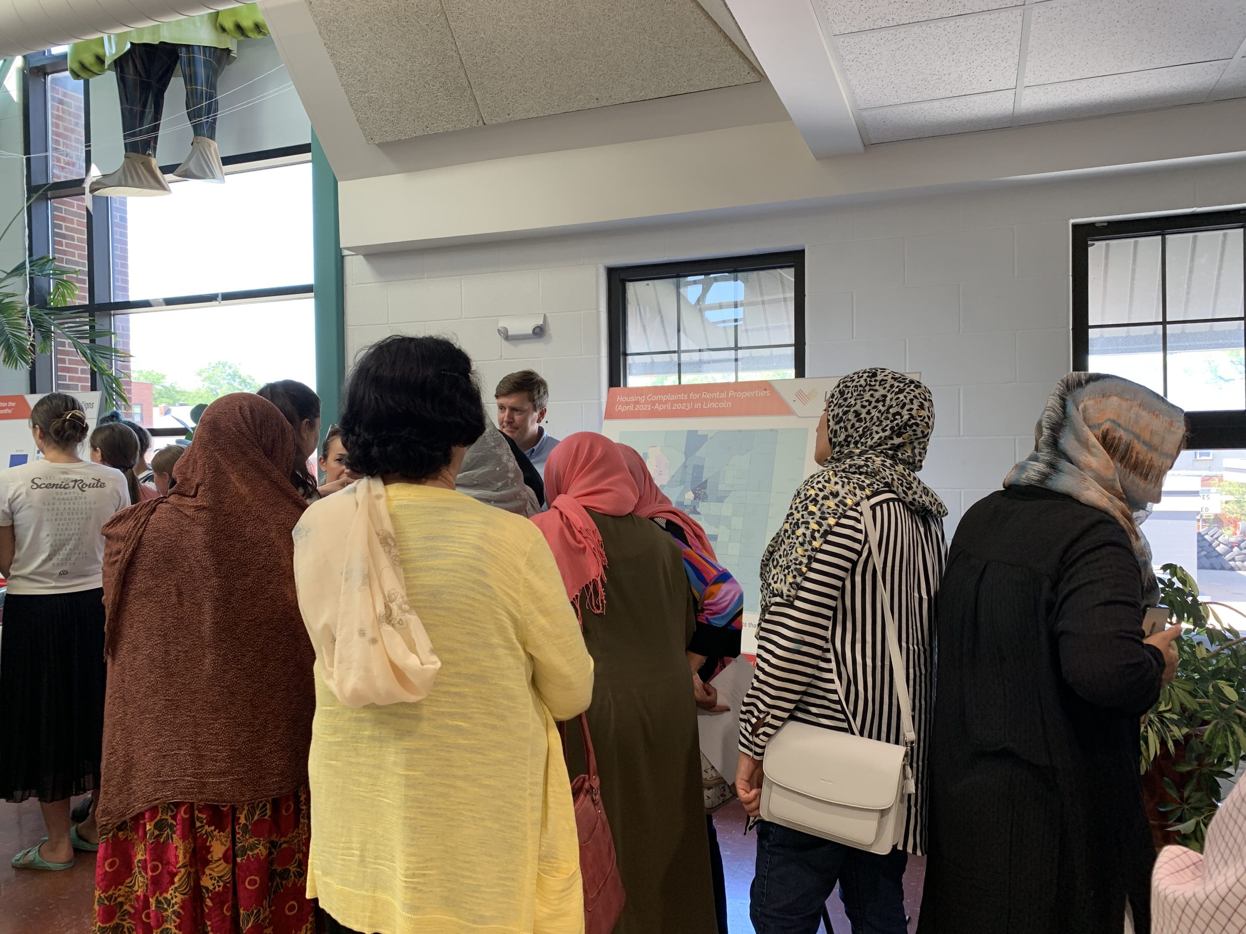 Photo of people looking at poster with local data.